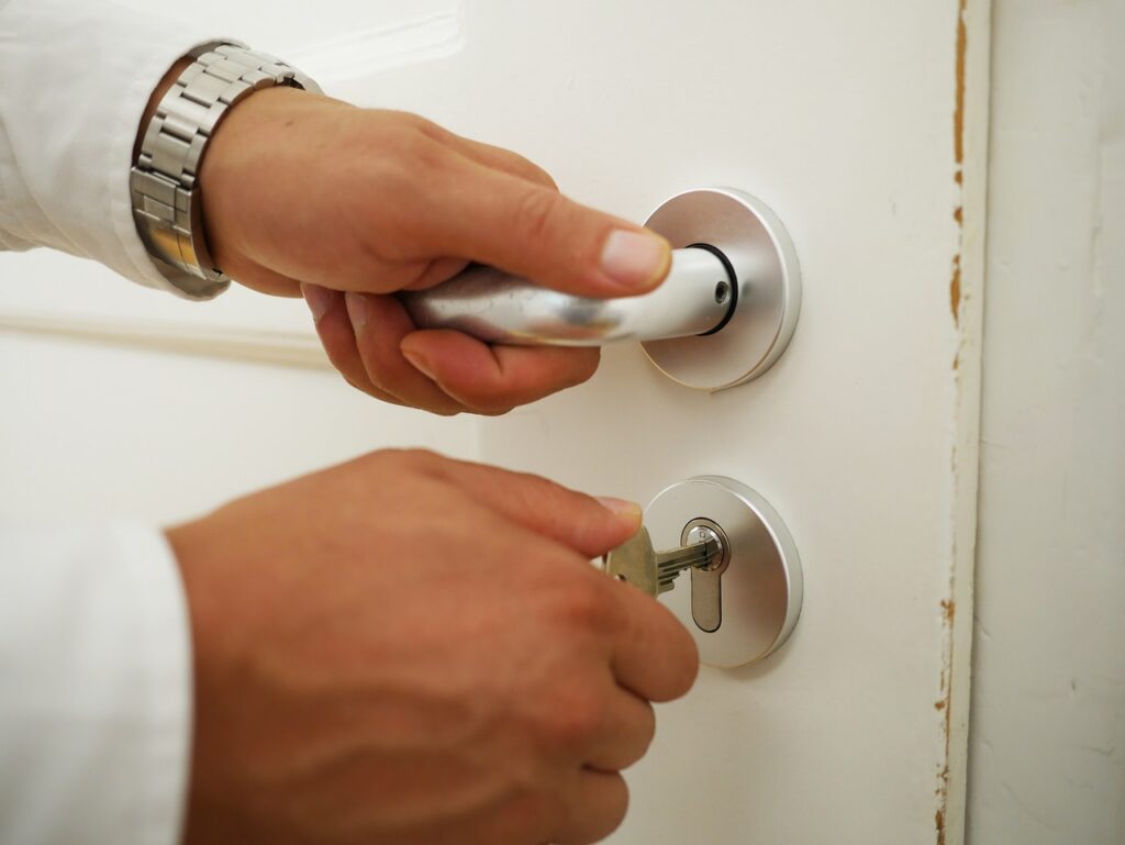 Close-up of a hand on a door lock, representing the repetitive checking cycle in OCD