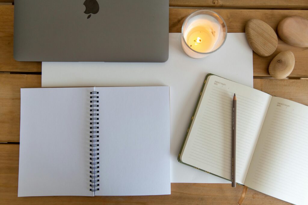 An open notebook and pen on a warmly lit desk, representing the structured, collaborative process of CBT and ERP therapy for OCD"